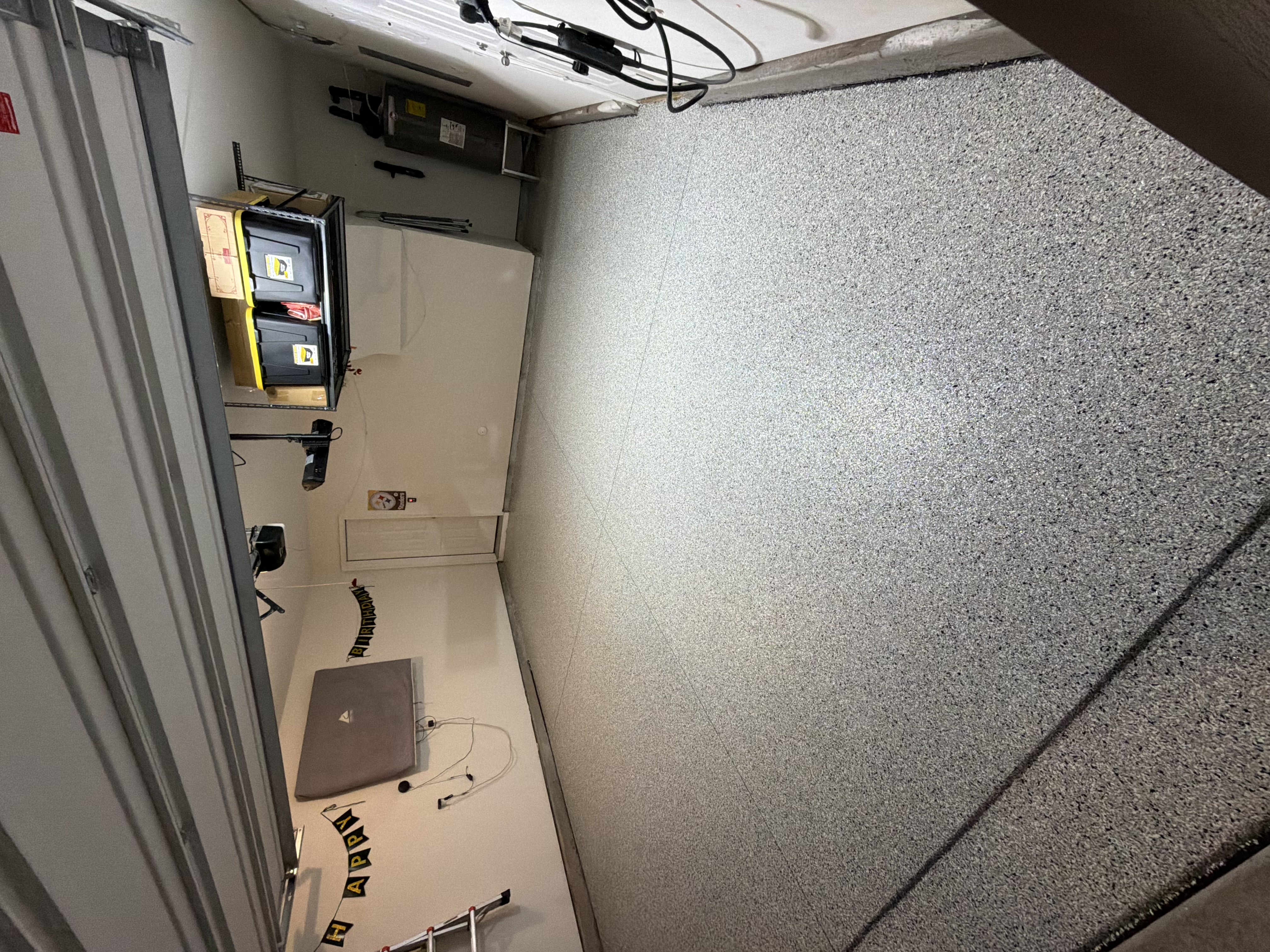 Vehicle parked in a covered garage with a sealed concrete floor