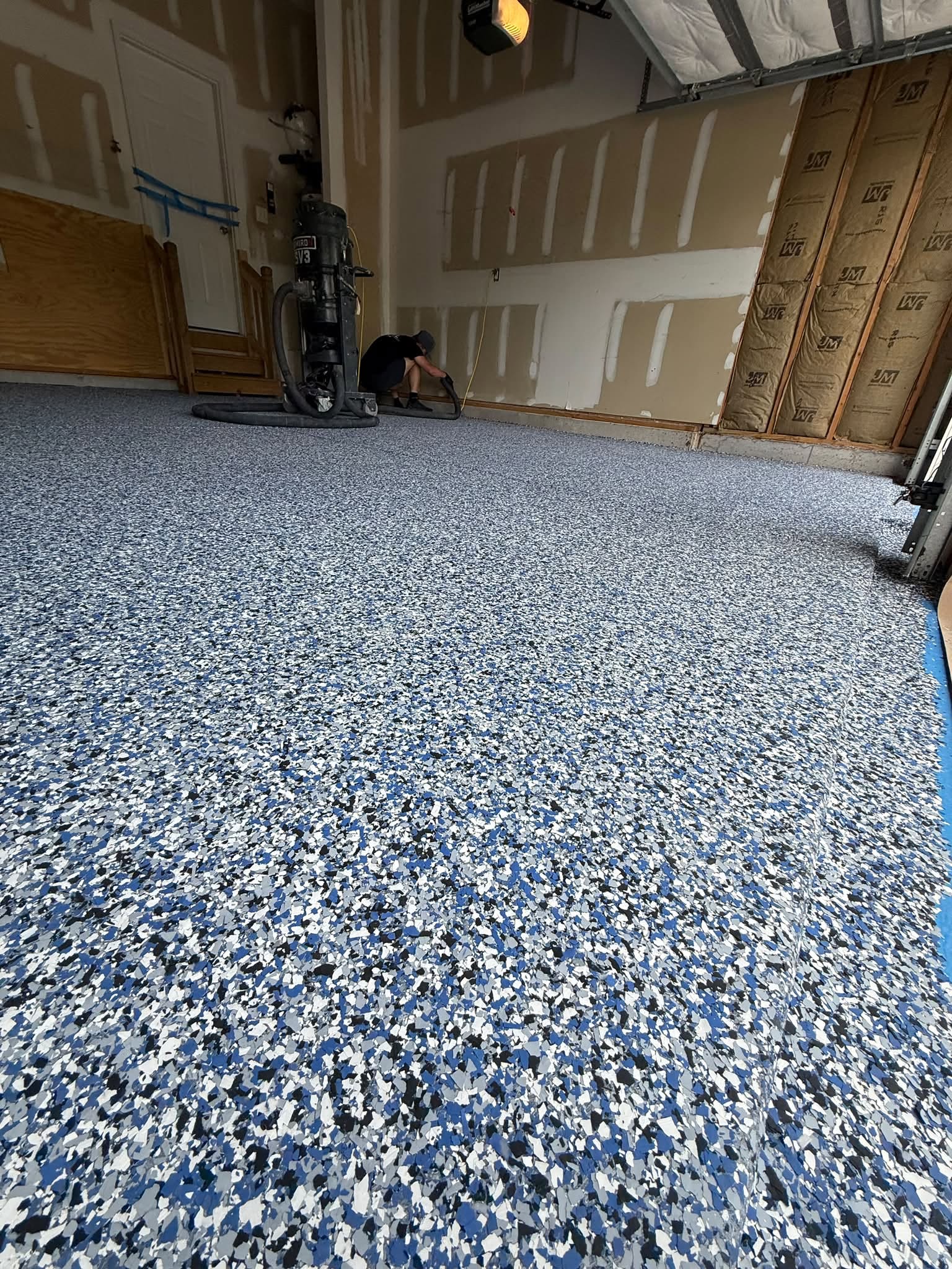 Sunlight reflecting on a wet, shiny epoxy floor finish